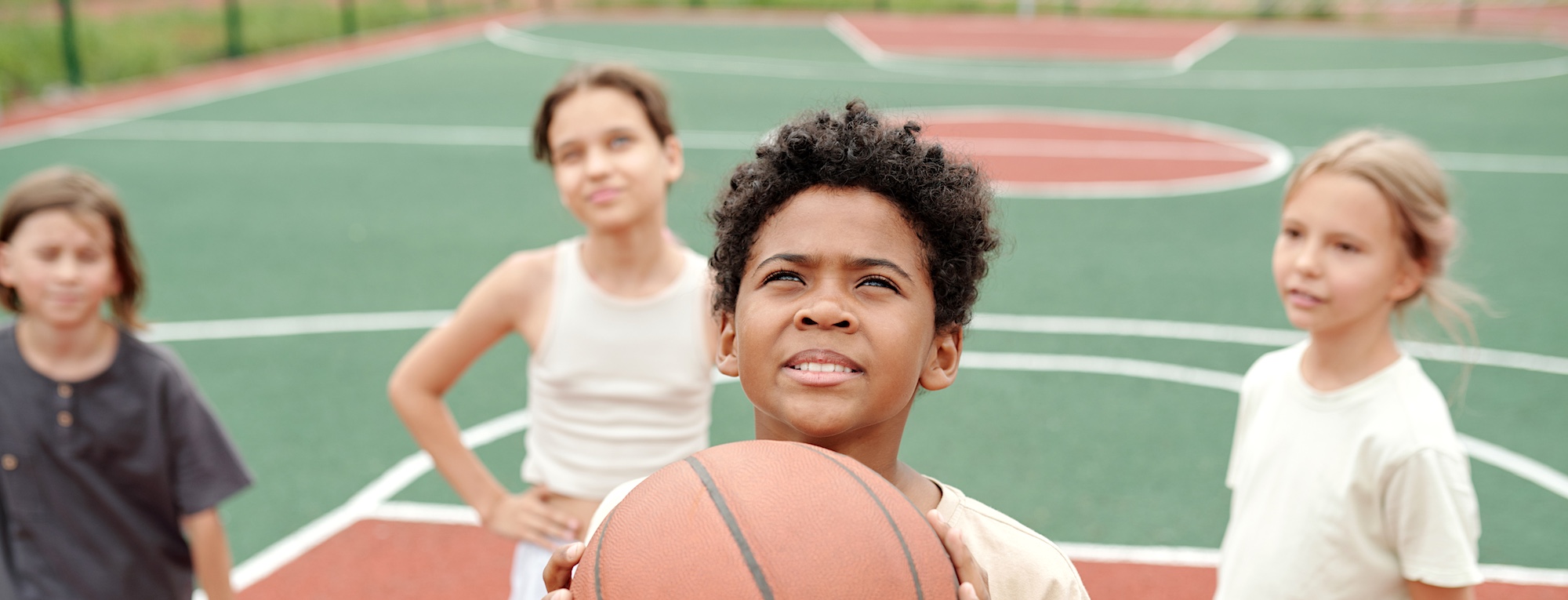 Children Playing Basketball on Basketball Court